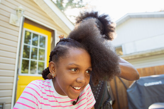 Mother combing her child's kinky curly coily hair