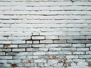 Old white ruined bricks on the wall in the public area.