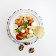 Warm salad with vegetables and cream sause and shrimps. Isolated on a white background.