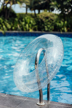 inflatable ring hanging on the ladder of swimming pool