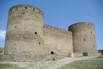Fototapeta na wymiar Ruins of the medieval castle wall in Europe in good weather 