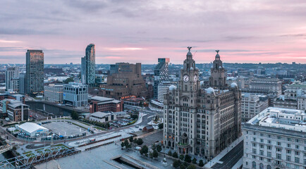 Aerial view with Royal Liver Building in Liverpool docklands in the city center, first rays at...