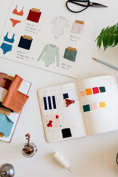 Still life from a notebook with designs of underwear and swimsuits.
