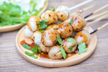 Meatballs on plate with with spicy sauce, Grilled meatball and pork ball, Meat ball on skewers and fresh coriander vegetables cabbage, Thai food Asian food Meat balls - pork balls