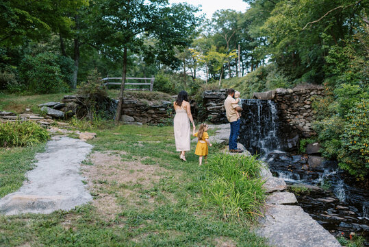 Family standing by a water fall
