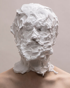 Portrait of a person with their head covered in shaving cream 