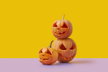 Three Halloween pumpkins on duotone background.