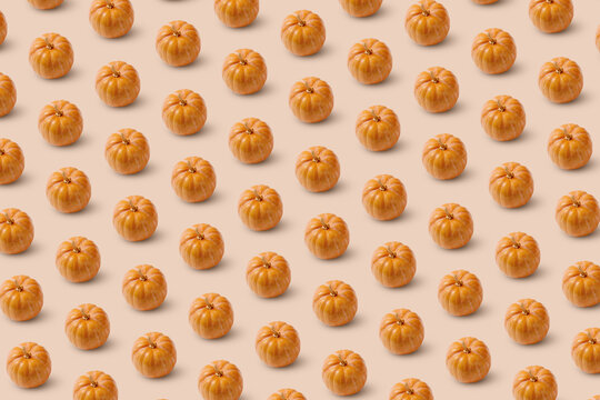 Pattern of carved Halloween pumpkins on beige.