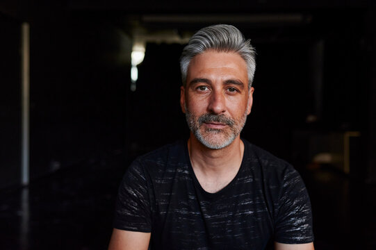 Male actor sitting in a studio