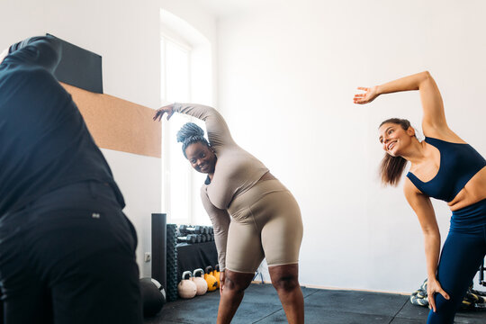 Women Exercising with Personal Trainer