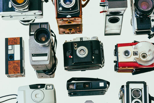 Collection of vintage film cameras arranged on a mirror