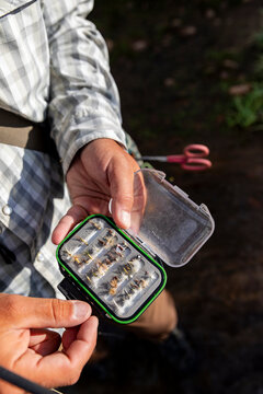 Hand with Fly Fishing Tackle Box  
