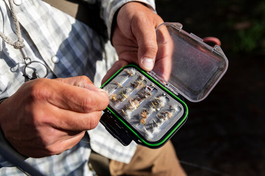 Fly Fishing Tackle Box  with hand choosing fly