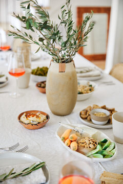 A table with a linen table cloth set for dinner.