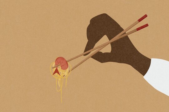 Prawn Chow Mein held in chopsticks.