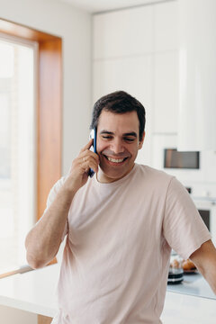 Mature male speaking on smartphone and smiling