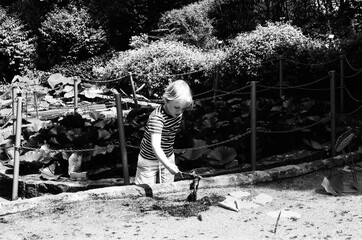 A curious boy playing outdoor near a pond