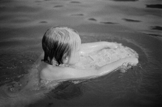A anonymous boy swimming 