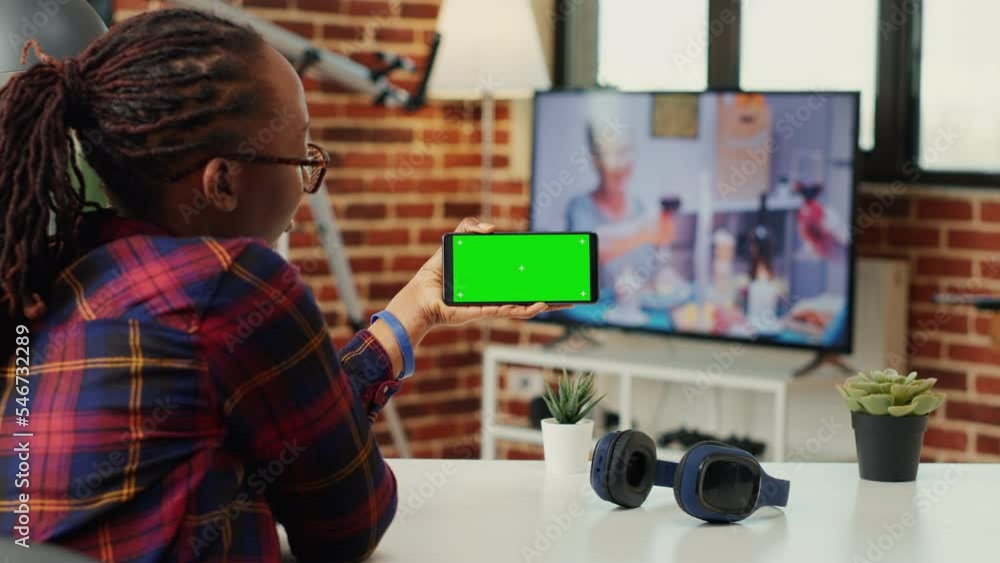 Aufkleber female freelancer looking at smartphone with greenscreen, analyzing horizontal chroma key display wi
