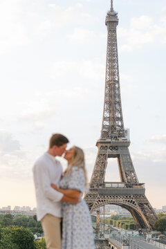 blurry couple by Eiffel tower