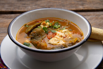 Mexican food. Tradicional rajas with cheese in red sauce.