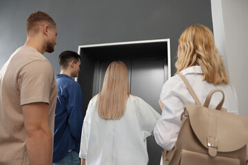 Group of people waiting for elevator in modern building © New Africa