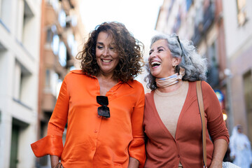 Senior women laughing together in the street