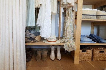 Organized closet with clothes and baskets