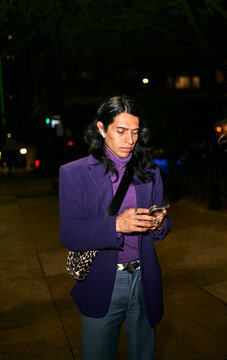 LGBT Latino male using  phone