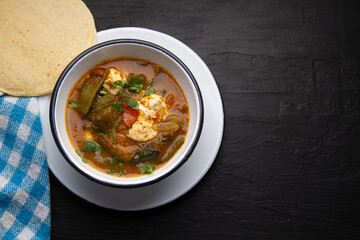 Mexican food. Tradicional rajas with cheese in red sauce.