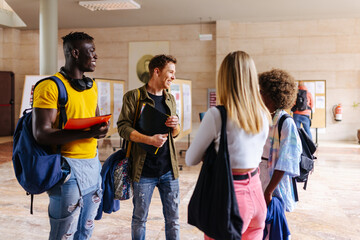 Group of diverse friends with backpacks at university