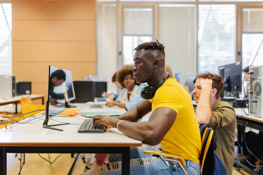 Black man working on computer at university
