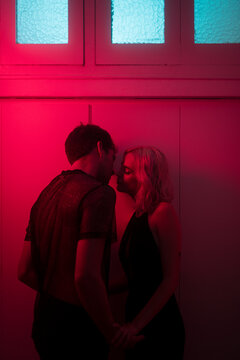Intimate lovers kiss during night party
