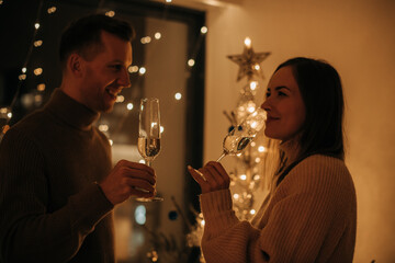 Couple in love drinking wine during New Year celebrations