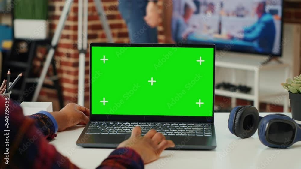Poster african american employee working with greenscreen template on laptop, using blank copy space backgr