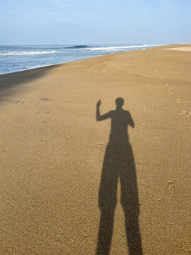 shadow of a person on the sand of a beach 