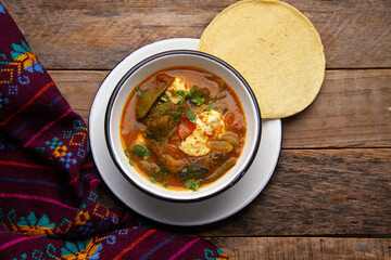 Mexican food. Tradicional rajas with cheese in red sauce.