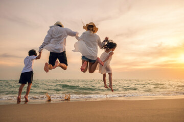 Happy family have fun jumping on beach in holiday at sunset, Back people enjoying travel trip and...