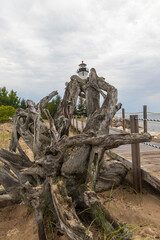 Fototapeta na wymiar Crisp Point Lighthouse and a tree root on the beach, Michigan