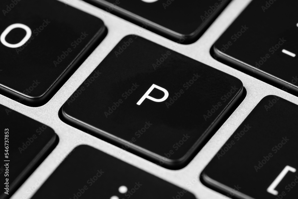 Poster closeup shot of a grey keyboard layout with black keys and white font