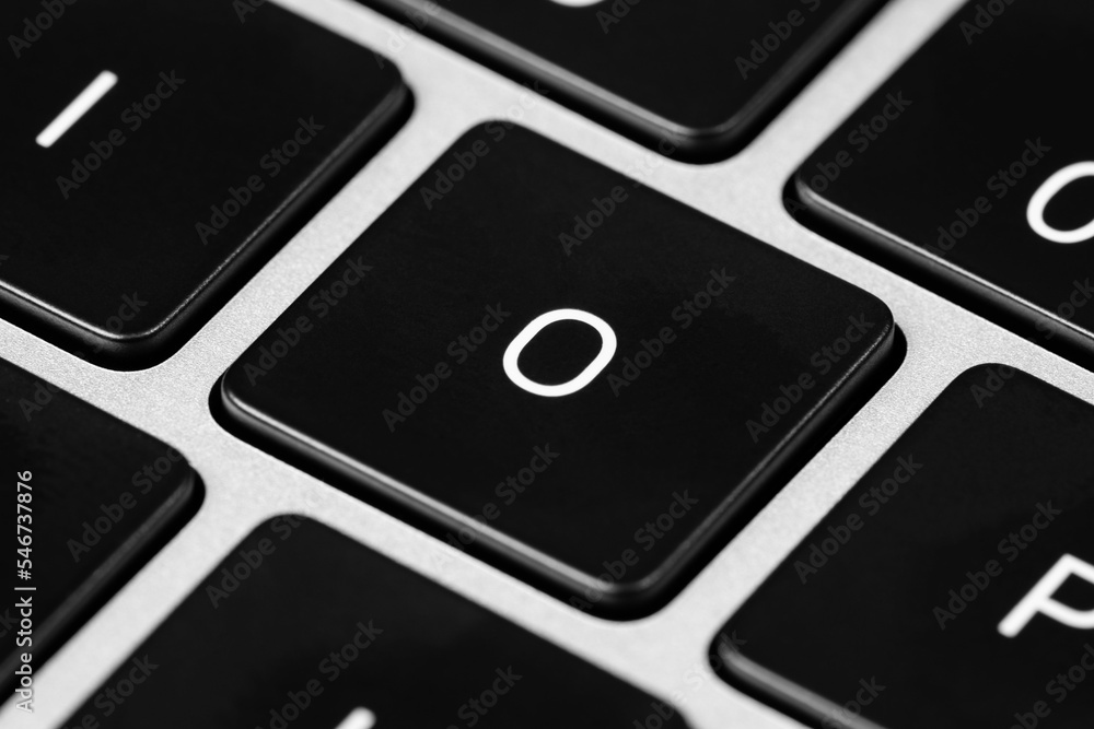 Poster closeup shot of a grey keyboard layout with black keys and white font