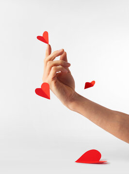 Person holding a small paper heart