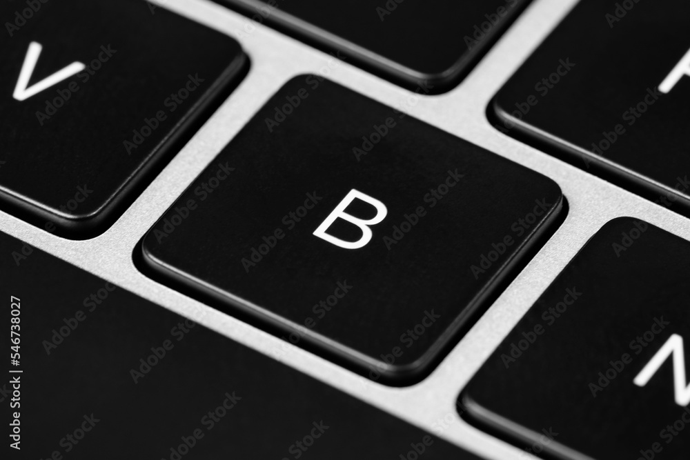 Poster closeup shot of a grey keyboard layout with black keys and white font