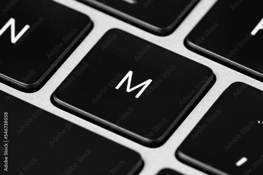 Poster closeup shot of a grey keyboard layout with black keys and white font