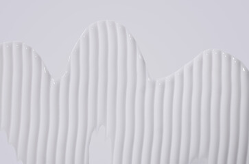 white cream swatch on a white background, skincare cosmetics texture	
