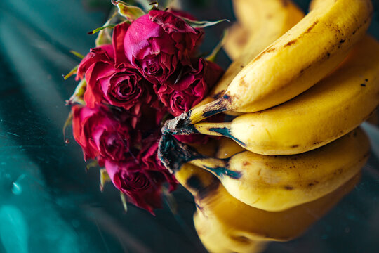 Still life with roses and bananas.