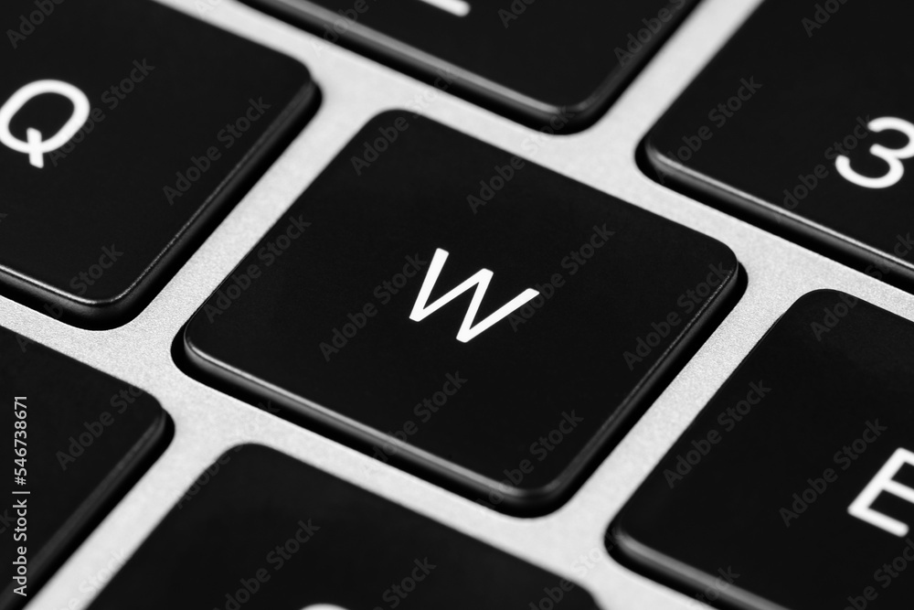 Poster closeup shot of a grey keyboard layout with black keys and white font