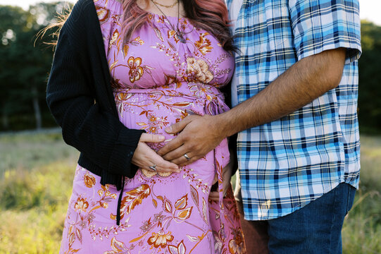 Close up of couple cradling pregnant belly