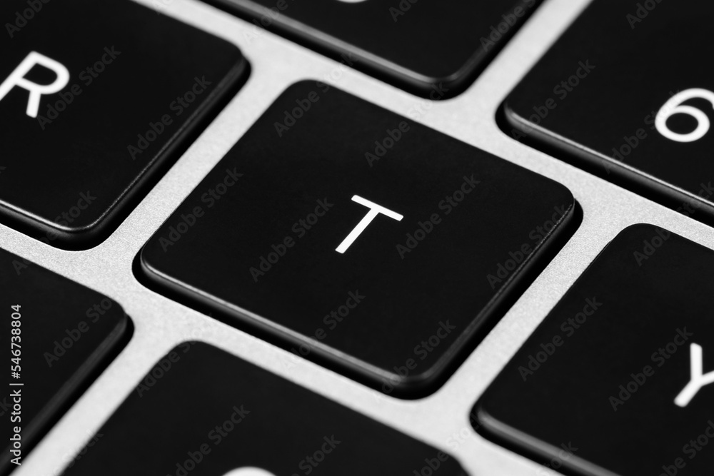 Poster closeup shot of a grey keyboard layout with black keys and white font
