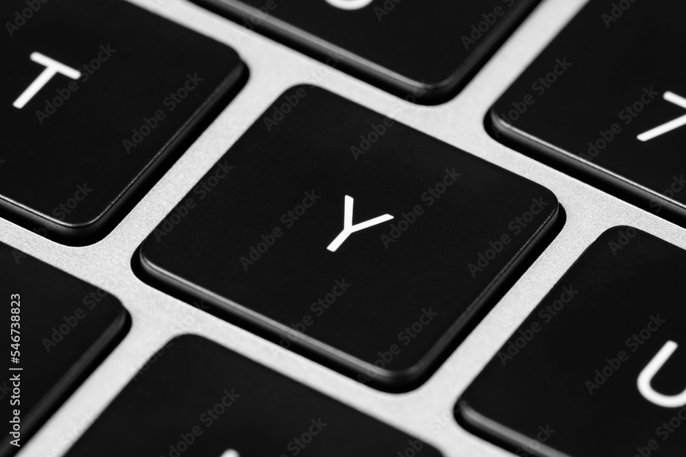 Poster closeup shot of a grey keyboard layout with black keys and white font